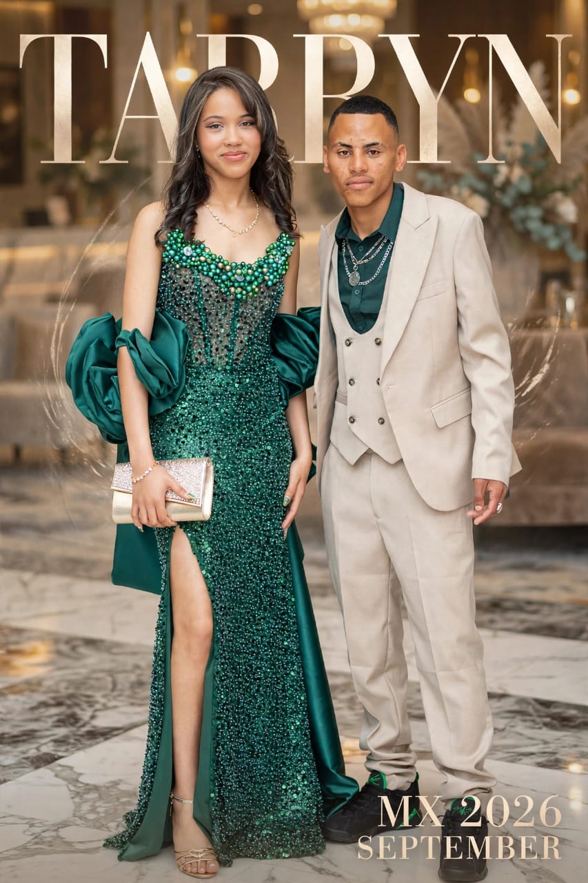 Matric ball couple in an emerald gown and cream suit